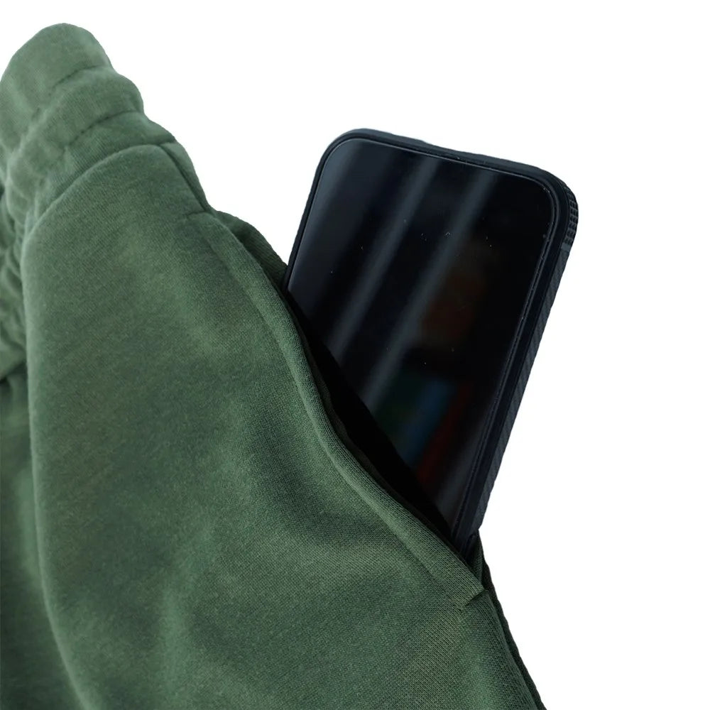 Men's fleece-lined joggers pocket holding a smartphone, showcasing functionality and convenience.