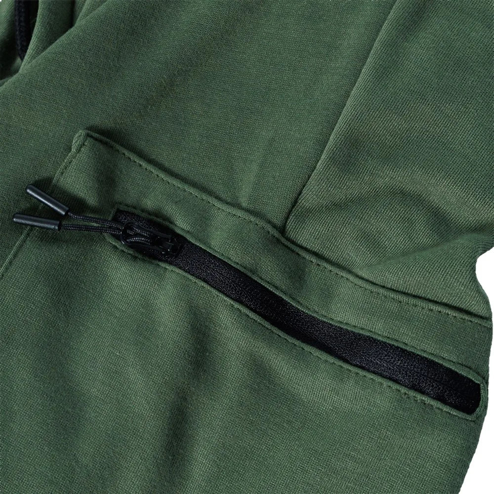Close-up of the zippered pocket on men's fleece-lined slim fit joggers in dark green fabric.