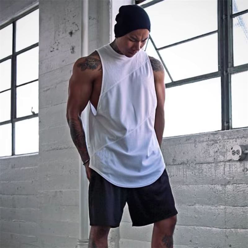 Model wearing a men's white mesh cotton gym tank top, showcasing quick-dry and breathable performance for workouts.