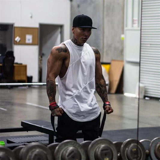 Muscular man in a white sleeveless tank top lifting weights in a gym, showcasing performance and comfort.