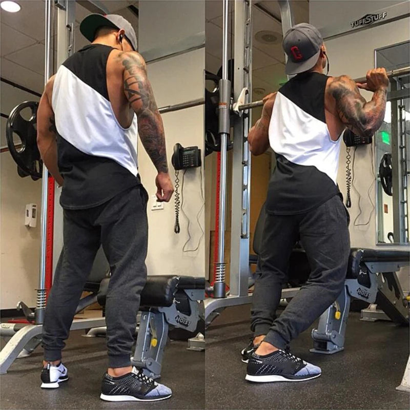 Man exercising in a gym wearing a Men’s Mesh Cotton Gym Tank Top, showcasing its quick-dry and breathable features.