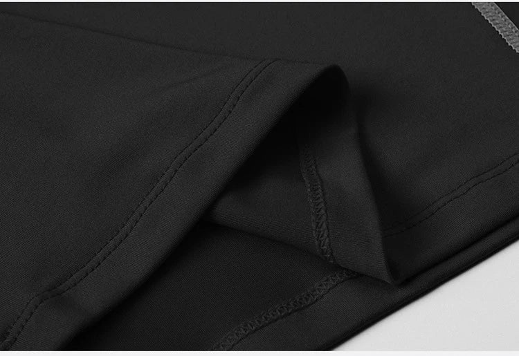 Close-up of lightweight fabric of a black men's workout vest, showcasing smooth stitching and quality material.