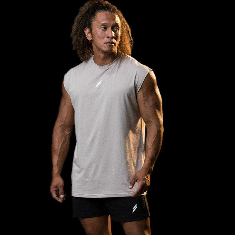 Man wearing a summer fitness sports tank top, featuring breathable fabric and a sleek design, ideal for workouts.