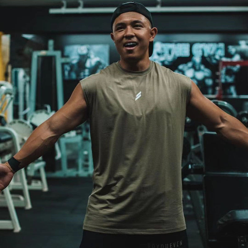 Man wearing a sleeveless Summer Fitness Sports Tank Top in a gym setting, demonstrating comfort during workouts.
