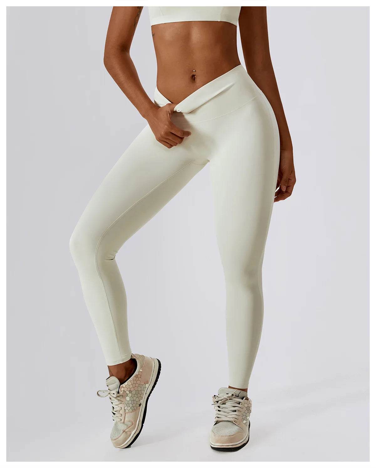 High-waist scrunch butt yoga leggings in cream color, featuring a secure fit and stylish design for active women.