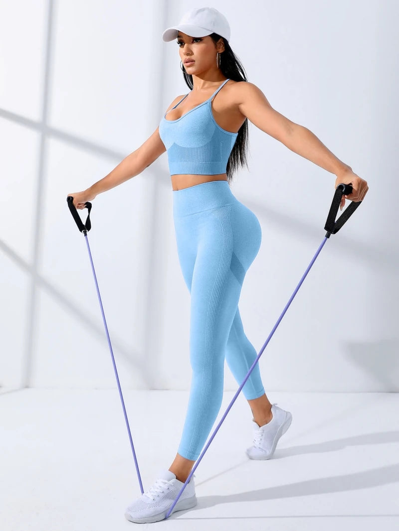 Woman in light blue seamless yoga set using resistance bands for workout, showcasing comfort and style.