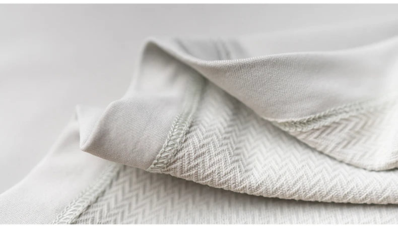 Close-up of fabric texture and neck detail of Men’s Speed-Dry Long Sleeve Fitness Top in light color.