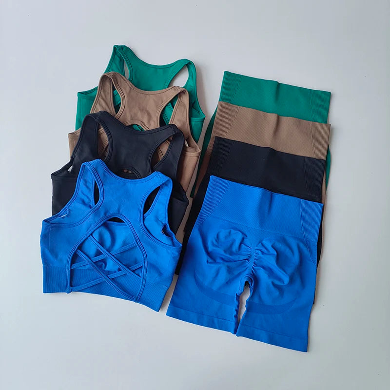 Colorful 2-piece seamless yoga set including sports bras and high-waisted shorts arranged neatly.