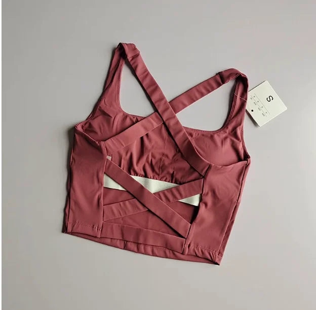 Seamless push-up sports bra for women, showcasing a stylish cross-back design in a rich rose color.