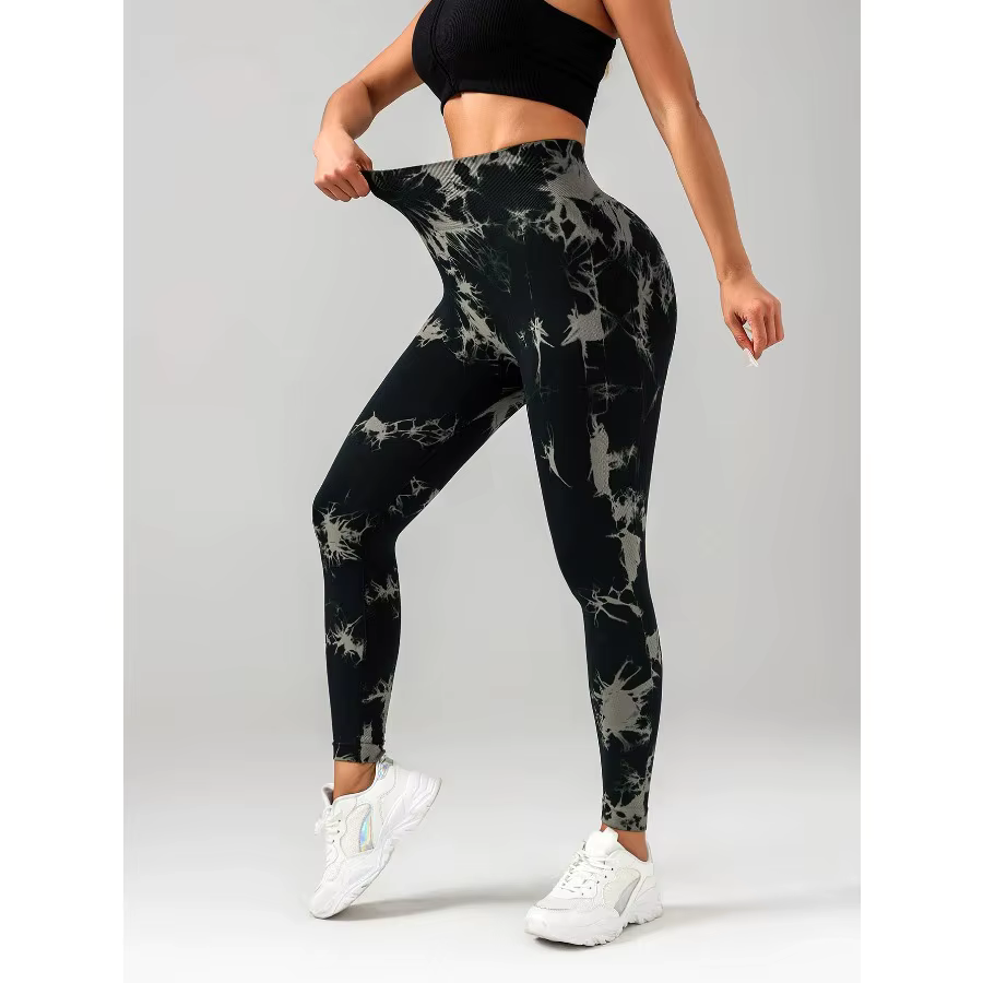 Model showcasing high-waisted tie dye seamless workout leggings in black and gray for activewear.