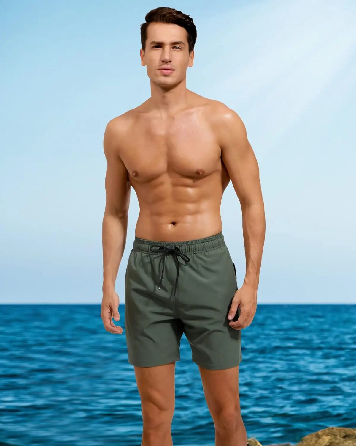 Model wearing men's 2-in-1 running shorts by the beach, showcasing a slim fit and stylish design.
