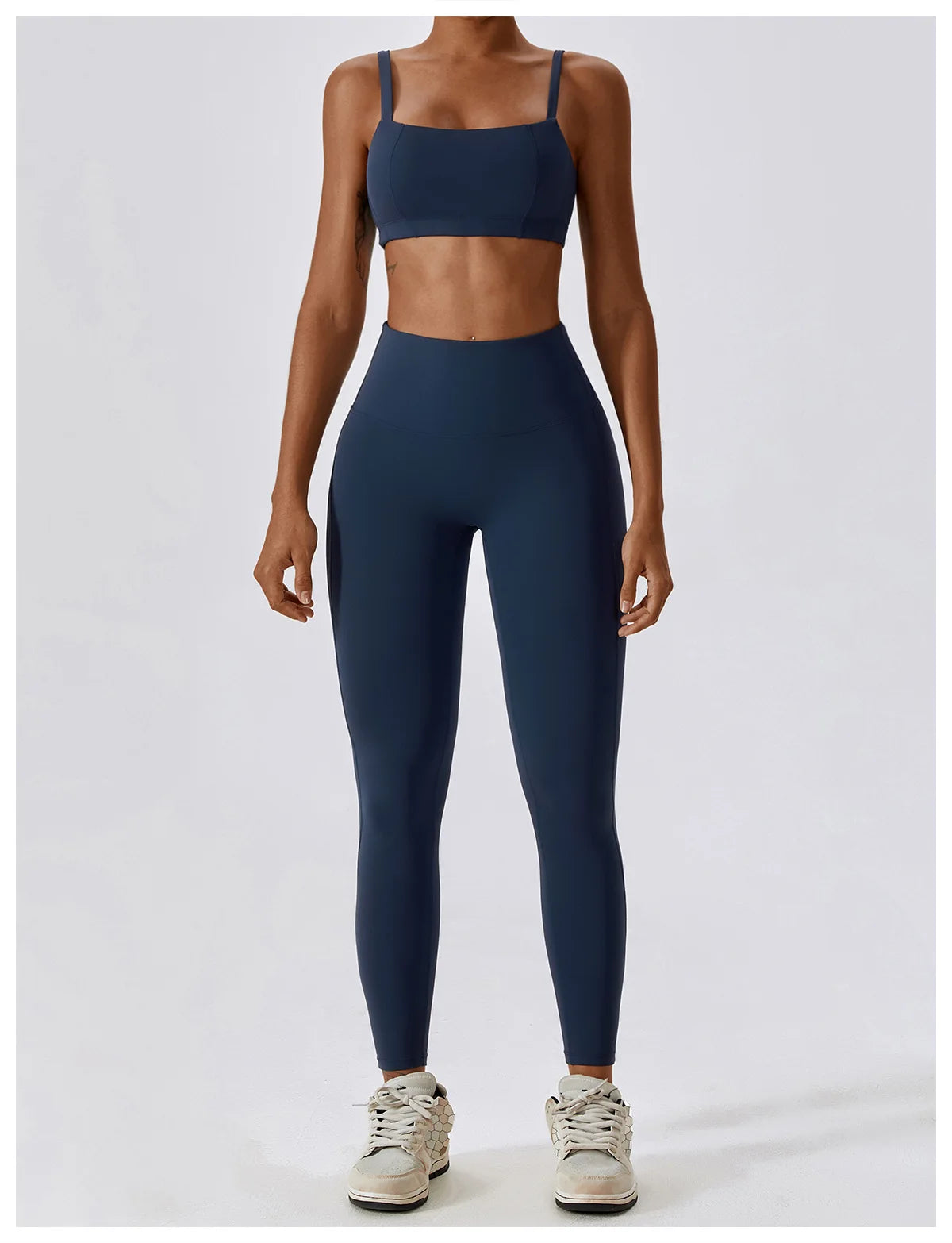 High-waist scrunch butt yoga leggings for women in dark blue, paired with a matching sports bra for a stylish workout look.