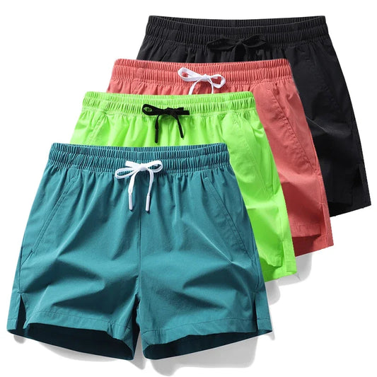 Colorful badminton performance shorts in teal, green, pink, and black, designed for optimal agility and comfort.