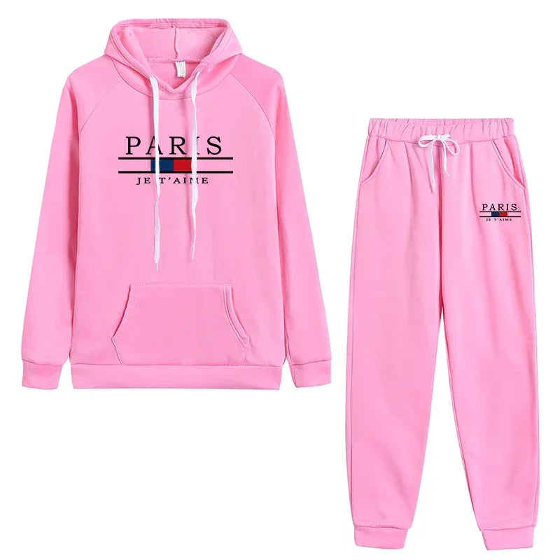 Casual pink sports jogging suit featuring a hoodie and pants with Paris print, ideal for workouts or lounging.