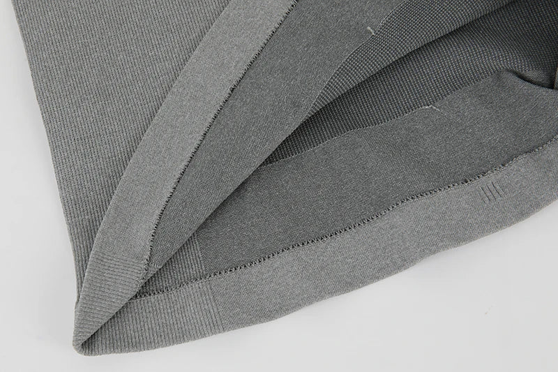 Close-up of the fabric and seams of a men's compression tank top in grey, showcasing quality design and materials.