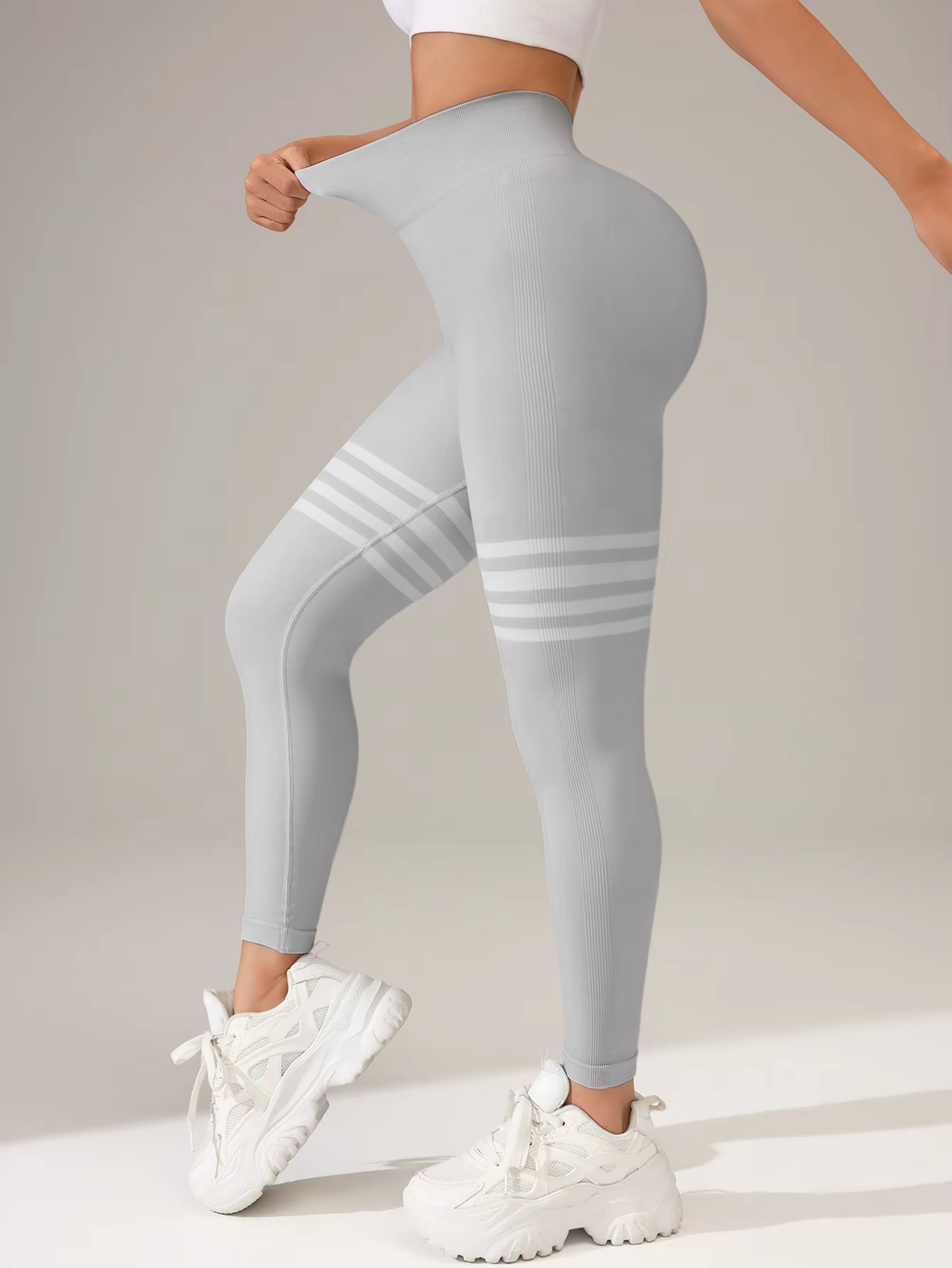Women’s striped high-waist compression leggings in light gray ideal for workouts and active days.