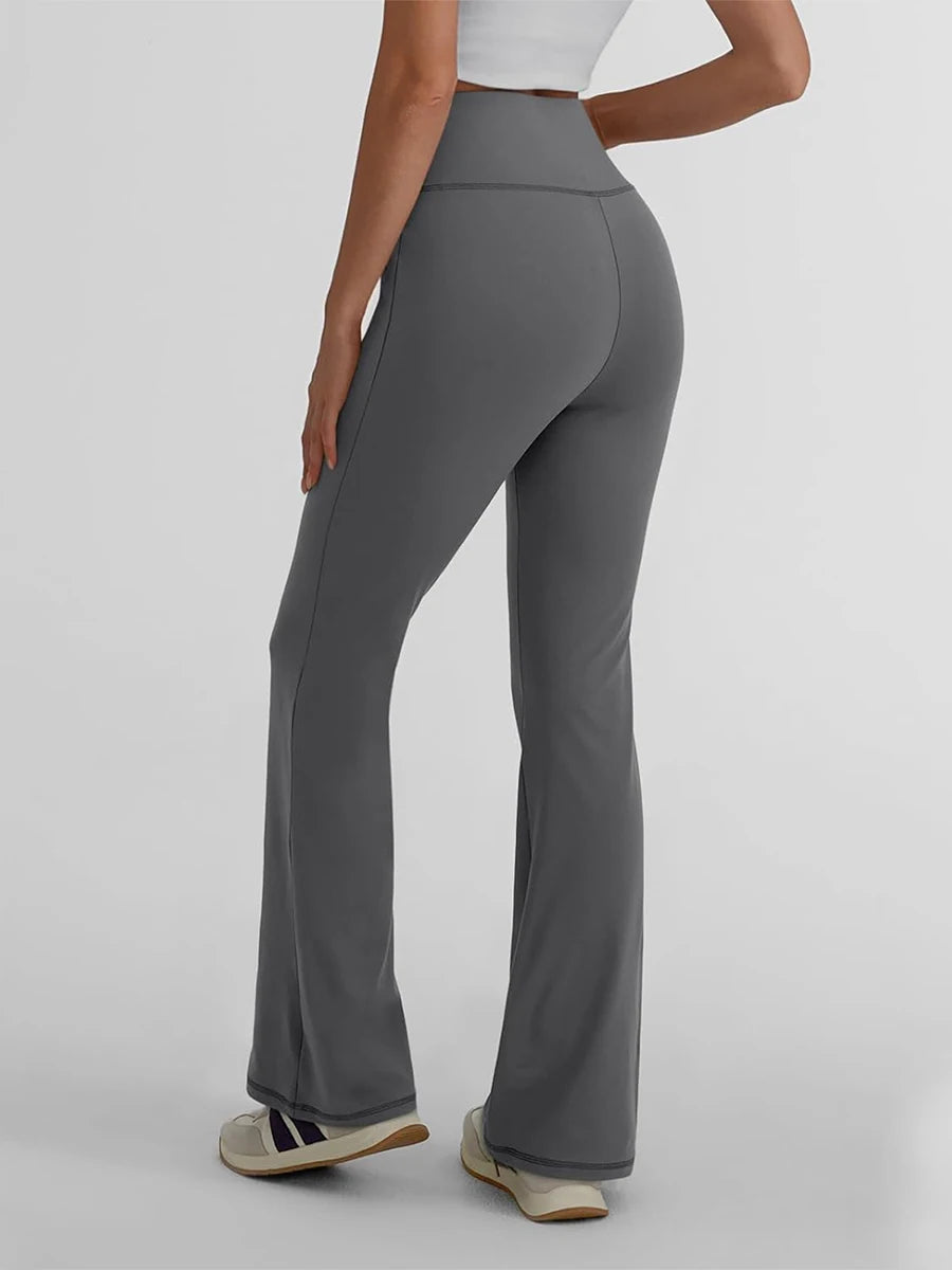 Back view of women's high waist yoga leggings in gray, showcasing a flattering fit and stylish activewear design.
