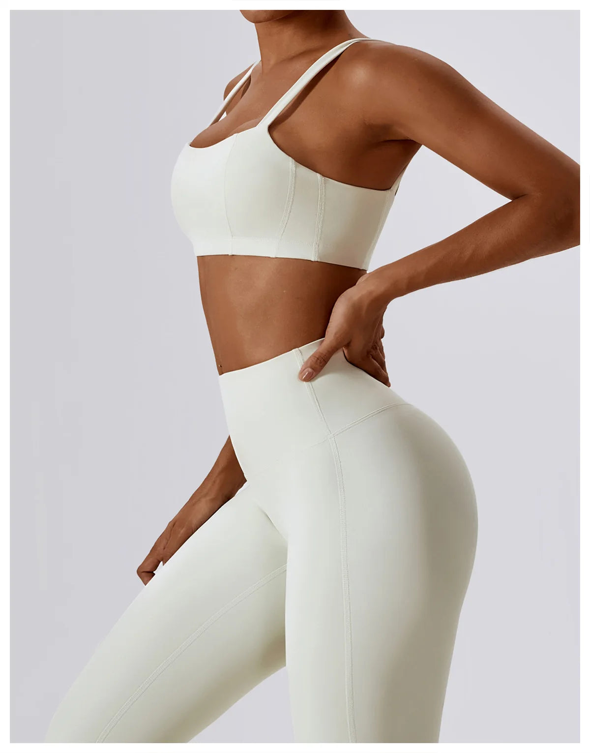 Model showcasing high-waist scrunch butt yoga leggings and matching sports bra in cream color.