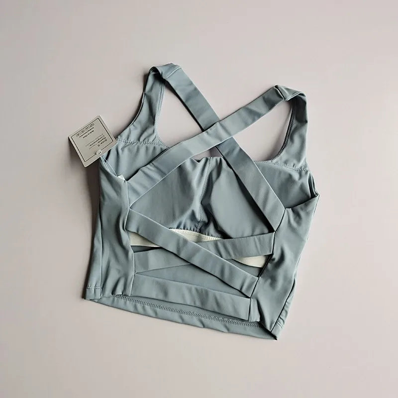 Light blue seamless push-up sports bra for women with stylish crisscross back design, perfect for workouts and yoga.
