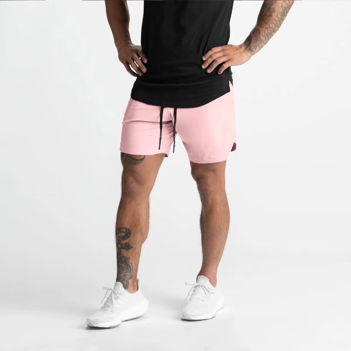 Model wearing men's lightweight single-layer gym shorts in pink, showcasing active style and comfort.