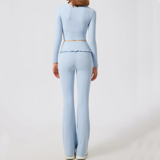 Back view of light blue women's yoga set with long sleeve crop top and high-waisted bell-bottom leggings.