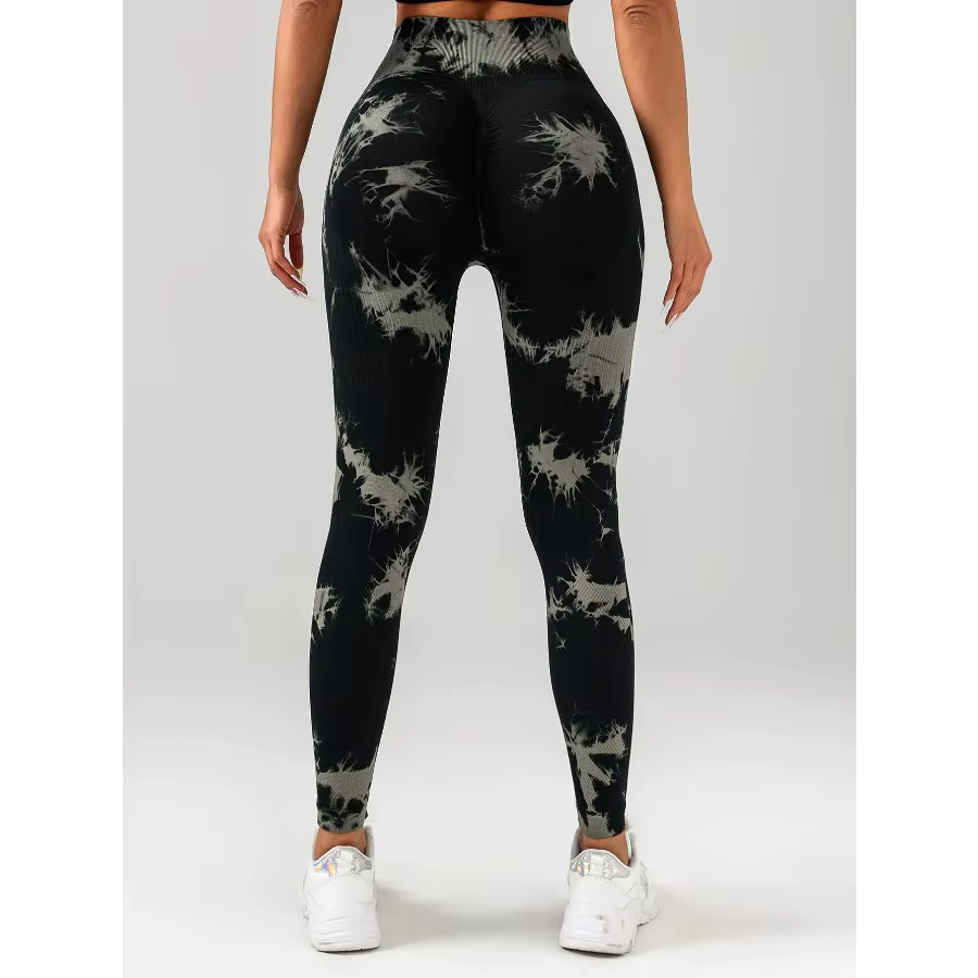 Back view of a woman wearing black and grey tie dye seamless workout leggings, highlighting comfort and style.