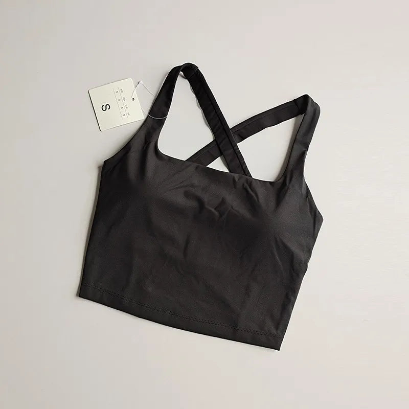 Black seamless push-up sports bra for women with crisscross straps, ideal for workouts and yoga.