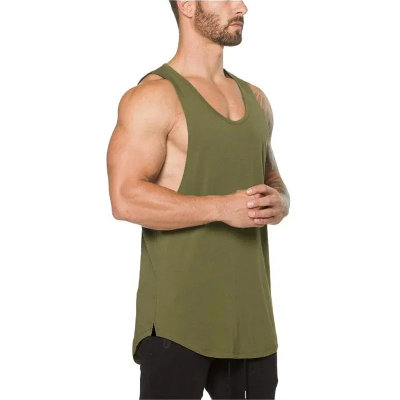Model showcasing a men's olive green sleeveless cotton tank top, perfect for workouts and outdoor activities.