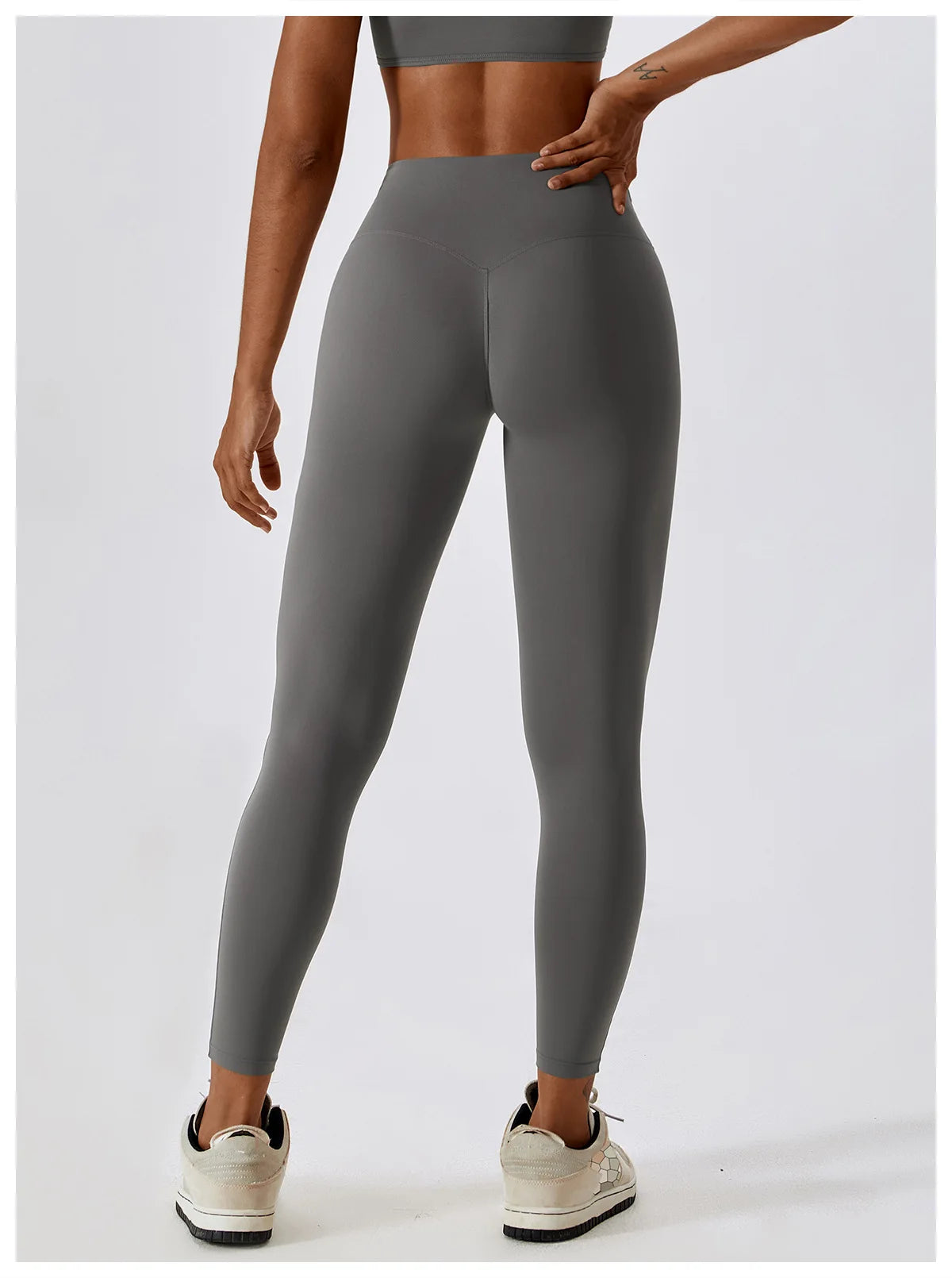 High-waist scrunch butt yoga leggings in grey, featuring a flattering fit and elastic waistband for comfort and support.