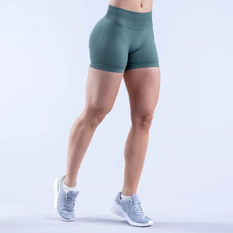 Model wearing Gym Impact Running Shorts in green, showcasing high-performance, moisture-wicking fabric for workouts.