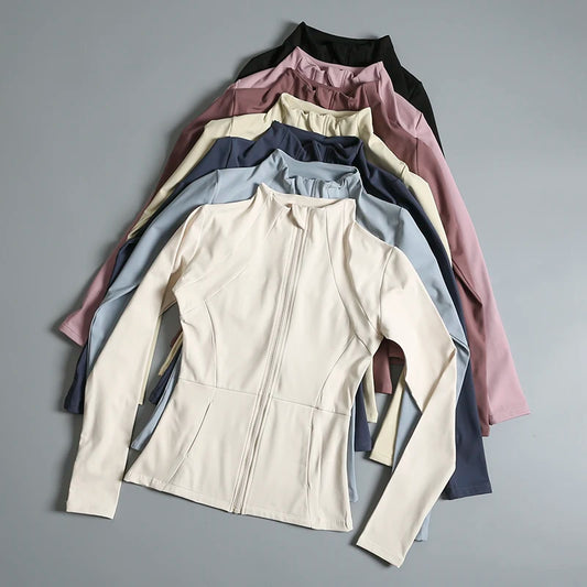 A variety of Women’s High-Elastic Long Sleeve Yoga Jackets in different colors arranged neatly.
