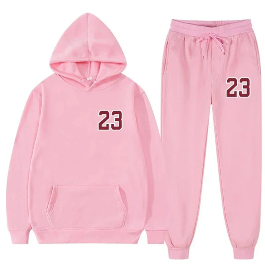 Pink hooded sweatshirt and sweatpants sports set featuring the number 23, perfect for workouts and casual wear.