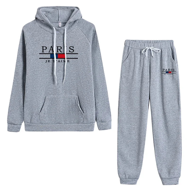 Casual sports jogging suit in gray featuring hooded sweatshirt and matching pants with 'PARIS' logo.