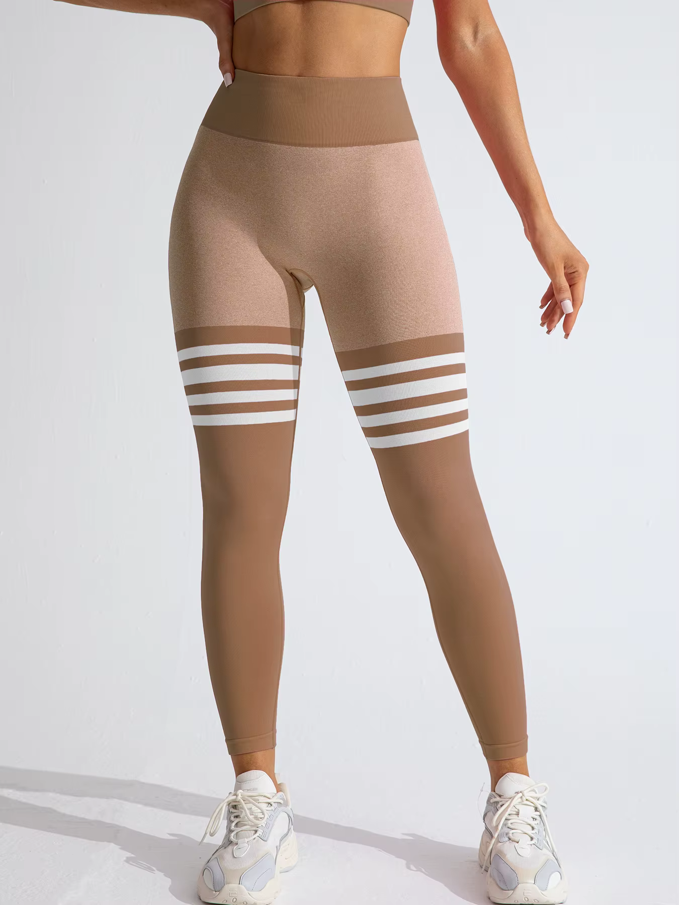Women’s Striped High-Waist Compression Leggings in brown with white stripes, perfect for workouts and stylish gym looks.
