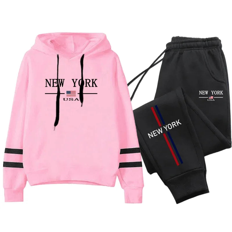 Casual women's pink hoodie and black tracksuit pants with 'New York' print, perfect for athleisure and comfort.