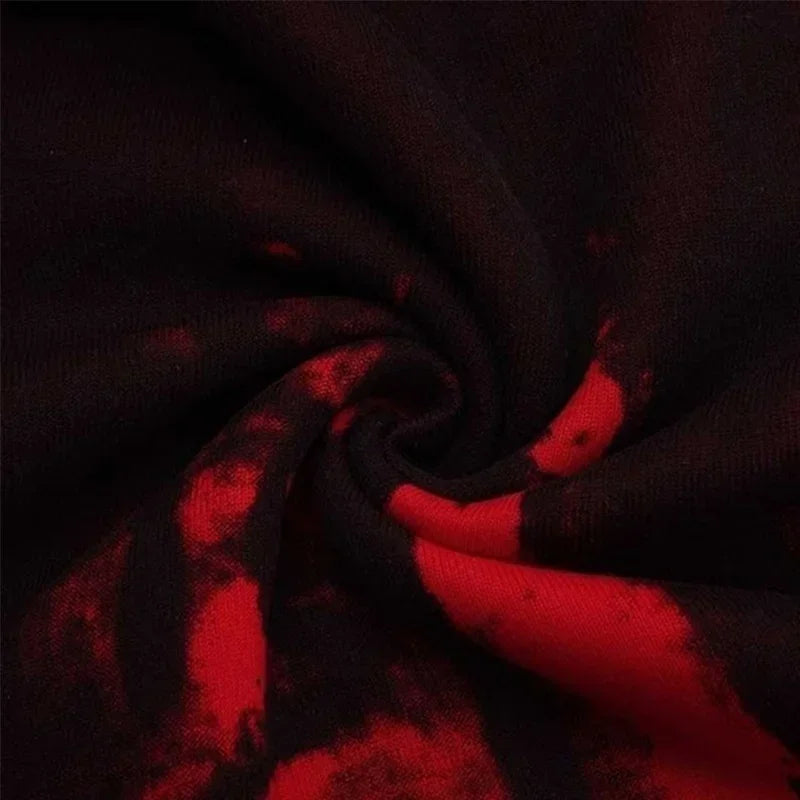 Close-up of black fabric with red tie-dye swirls, showcasing soft texture ideal for casual wear.
