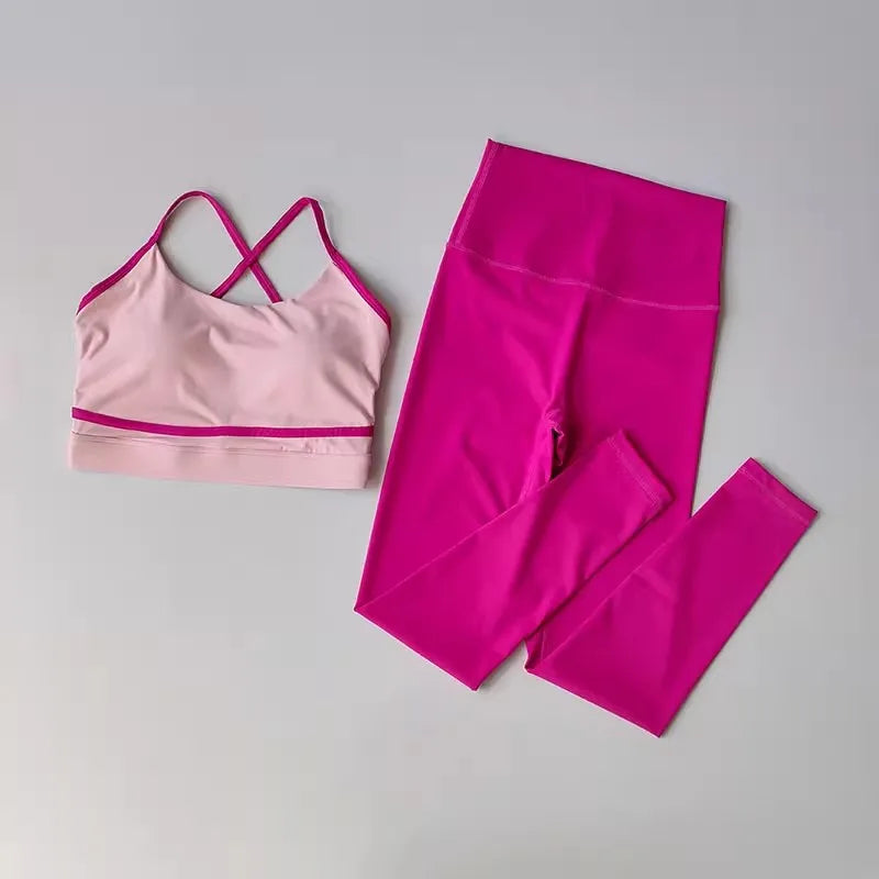 2-piece women's yoga set with a pink sports bra and high-waisted leggings on a gray background.
