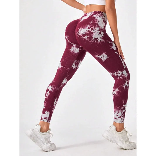 Model wearing maroon tie dye seamless workout leggings showcasing a flattering fit and stylish design.