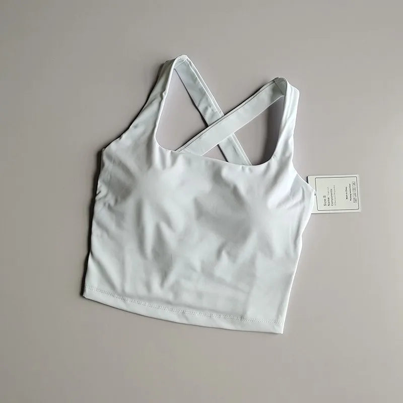 Seamless push-up sports bra for women in white, featuring a stylish cross-back design.