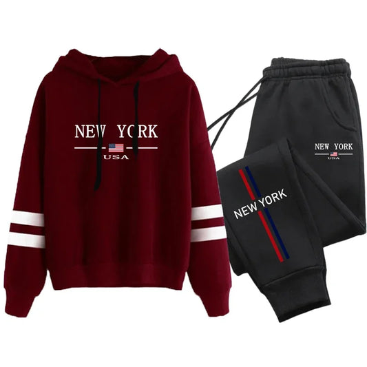 Casual women's tracksuit featuring a red hoodie and black joggers with 'New York' print for stylish athleisure wear.