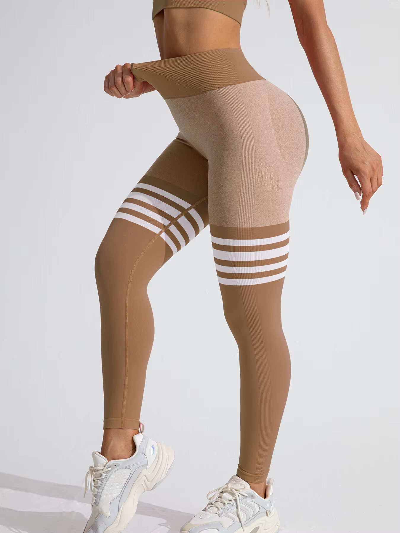 Women’s Striped High-Waist Compression Leggings in tan, showcasing stylish design and supportive fit for workouts.