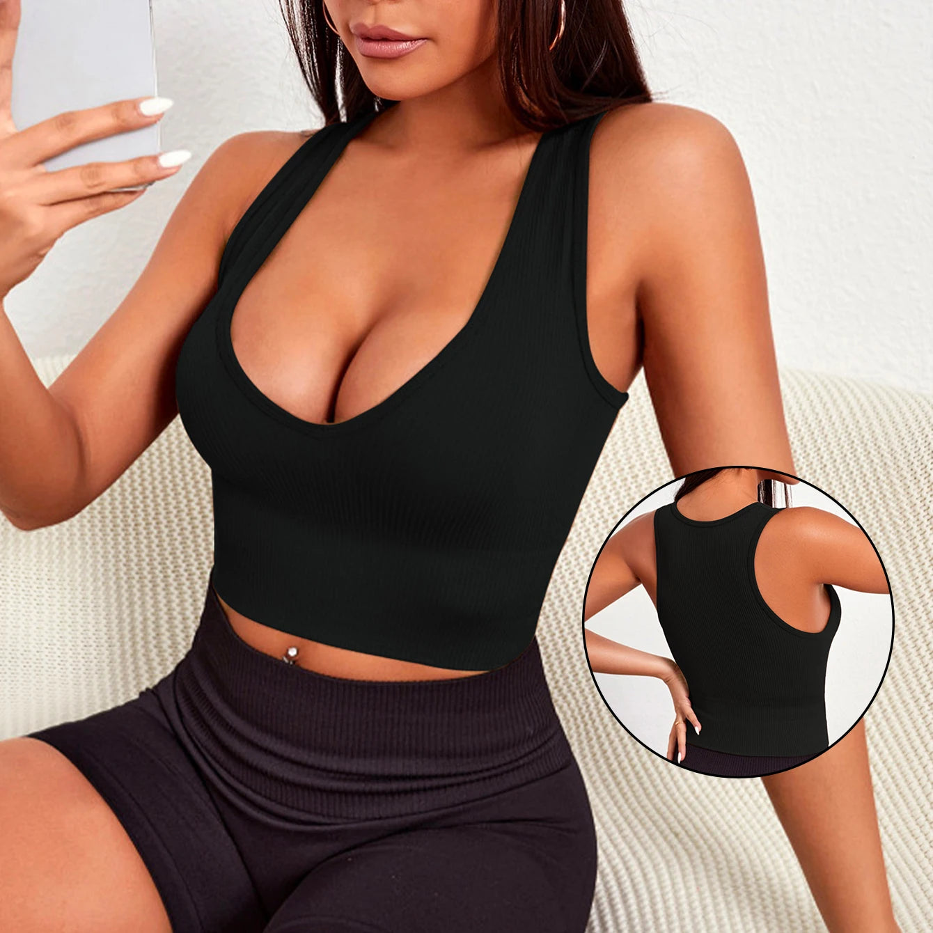 Model wearing a black seamless ribbed yoga vest, showcasing its sleek design and breathable fabric for activewear.