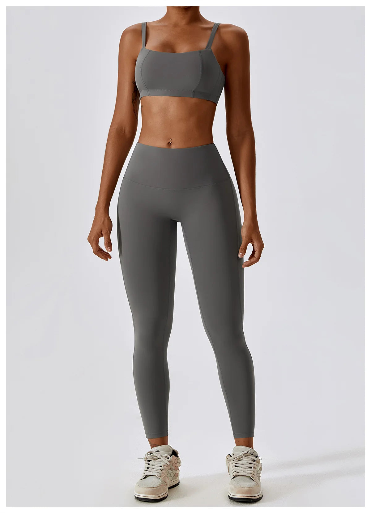 Woman wearing high-waist scrunch butt yoga leggings and sports bra in gray, showcasing comfort and style for active wear.