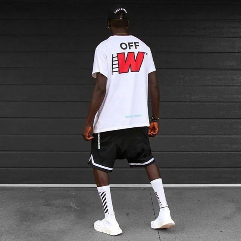 Back view of a model wearing a white graphic tee and black basketball shorts, showcasing a stylish casual look.
