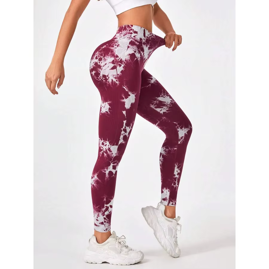 Woman in burgundy and white tie dye seamless workout leggings, showcasing high-waisted design and stylish fit.