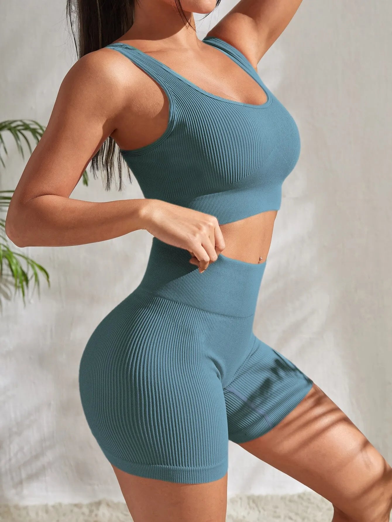 Women’s seamless ribbed yoga set featuring a blue crop tank and high-waisted shorts for fitness and yoga.