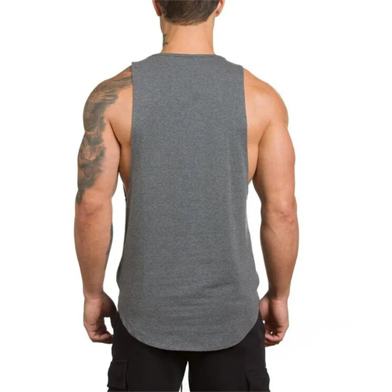 Back view of a man wearing a breathable cotton sleeveless t-shirt in gray, perfect for workouts and outdoor activities.