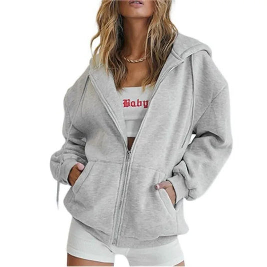 Women's gray zip-up hoodie with pockets, stylish and cozy, perfect for layering in autumn and winter.