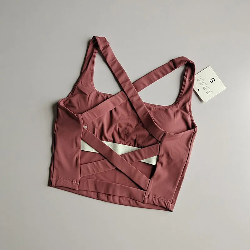 Seamless push-up sports bra for women in mauve with stylish crisscross back design, perfect for workouts.