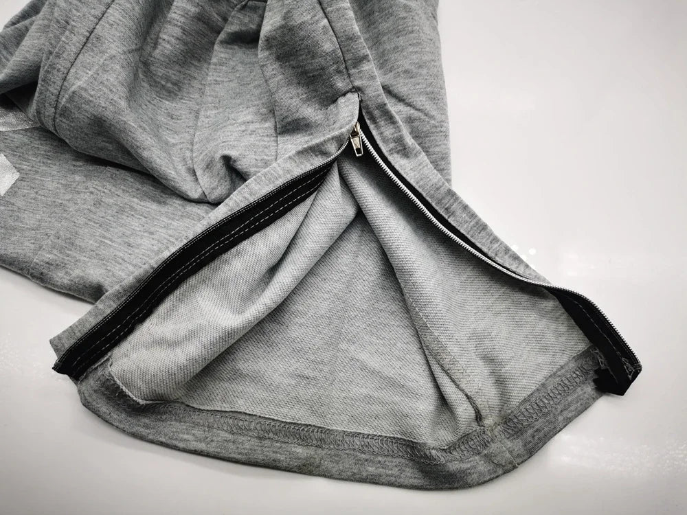 Close-up of the zipper detail on Men’s Performance Training Pants, showcasing the comfortable gray fabric and design.